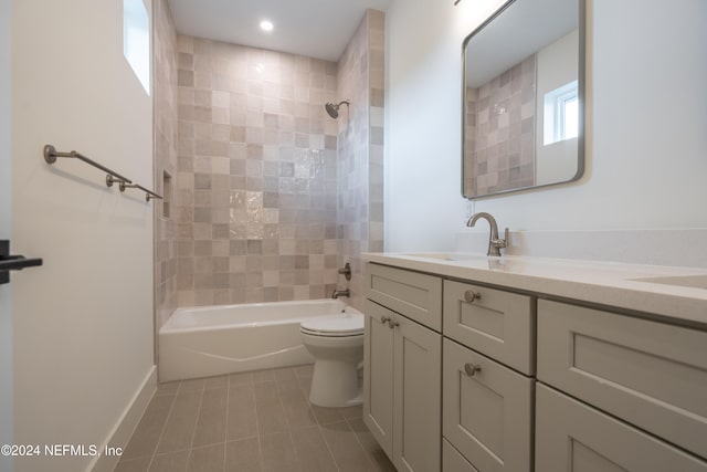 full bathroom with vanity, tiled shower / bath combo, and toilet