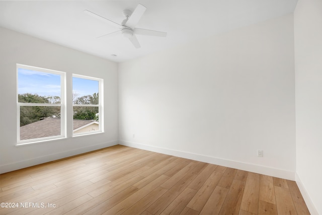 spare room with ceiling fan and light wood-type flooring