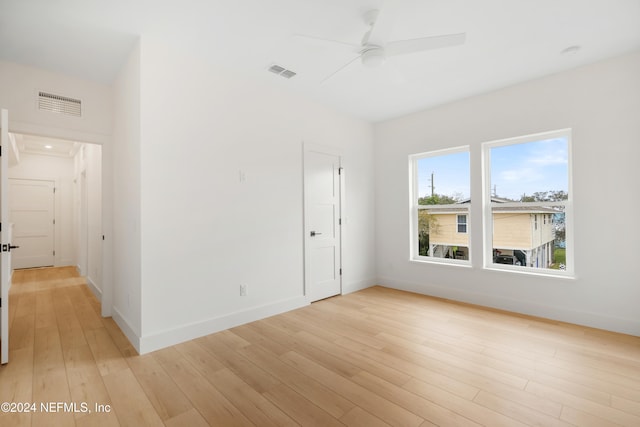 empty room featuring ceiling fan and light hardwood / wood-style floors