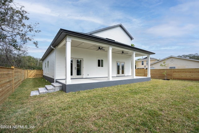 rear view of house featuring french doors, a patio, ceiling fan, and a yard