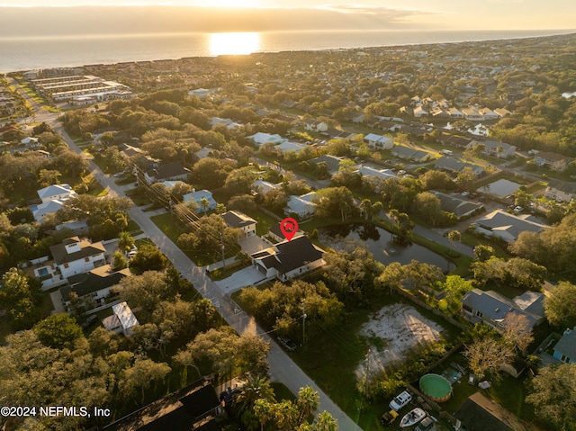 aerial view at dusk with a water view