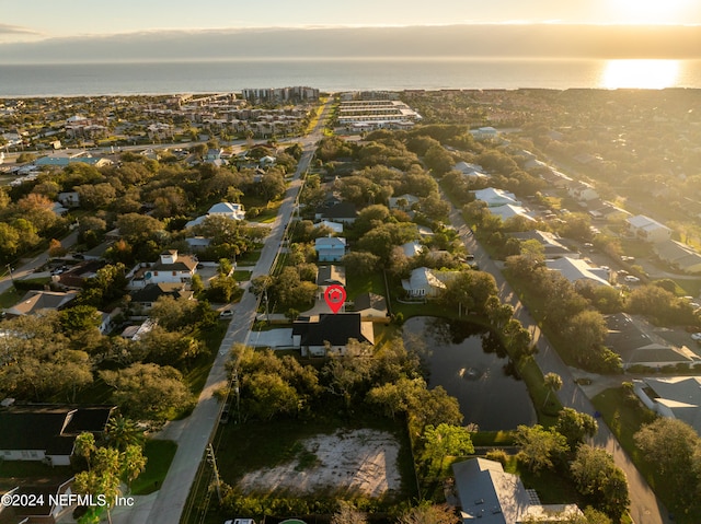 aerial view at dusk with a water view