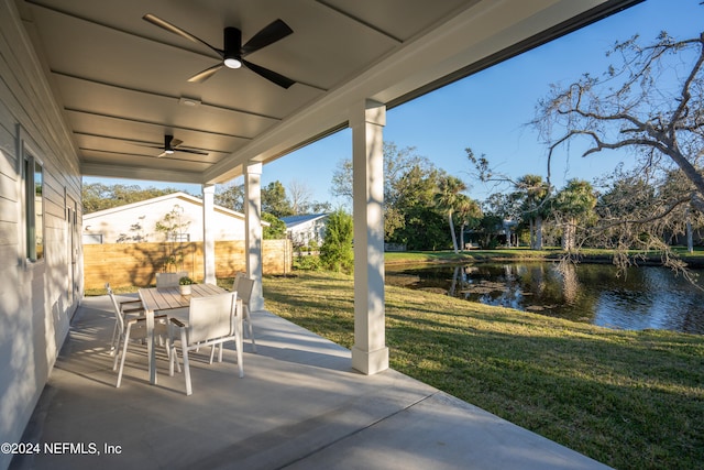 view of patio / terrace featuring ceiling fan and a water view