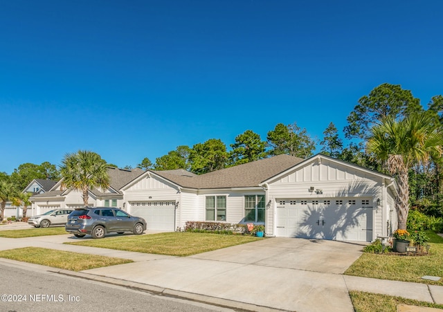 view of front of home with a front yard and a garage