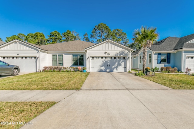 view of front of house featuring a front lawn and a garage