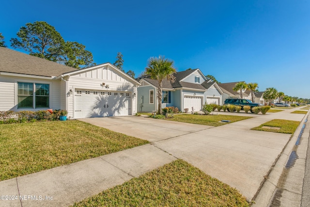 view of front of house featuring a front yard and a garage