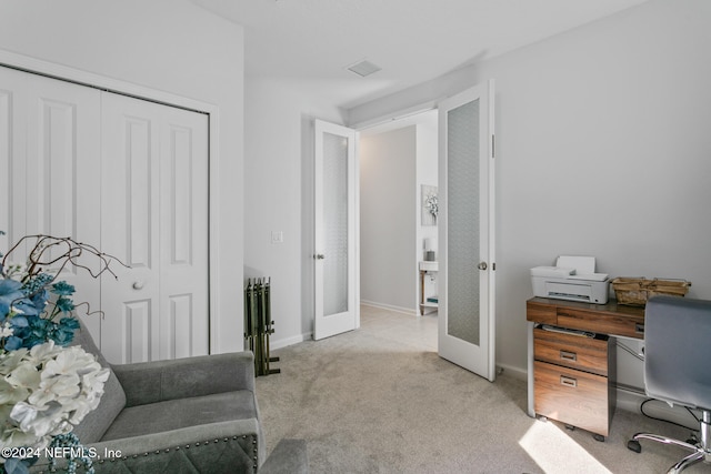 office with light colored carpet and french doors