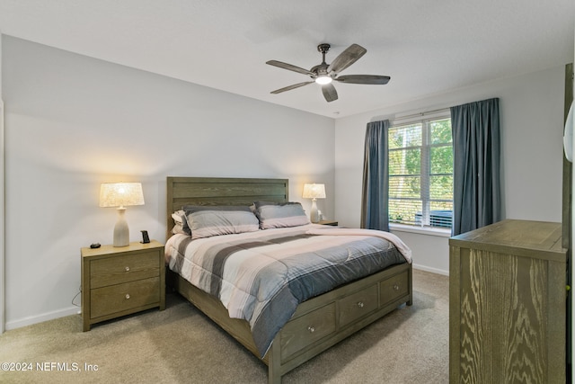 bedroom with ceiling fan and light colored carpet