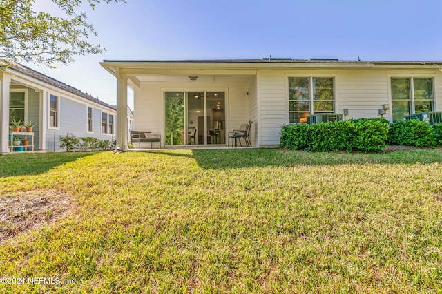 rear view of house with a lawn