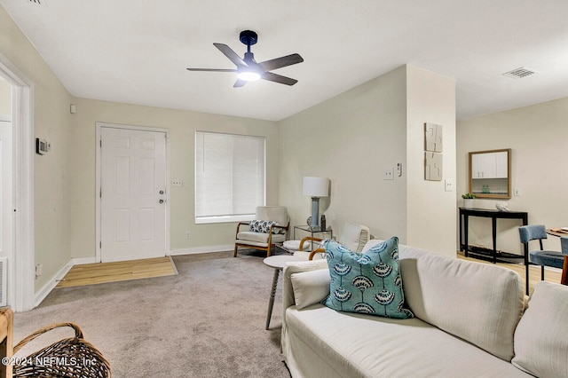 living room with ceiling fan and light carpet