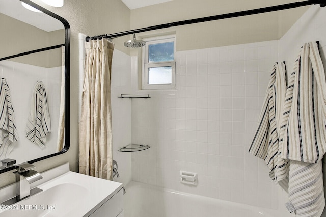 bathroom featuring shower / bath combo and vanity