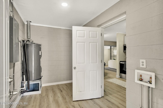 interior space featuring electric panel and water heater