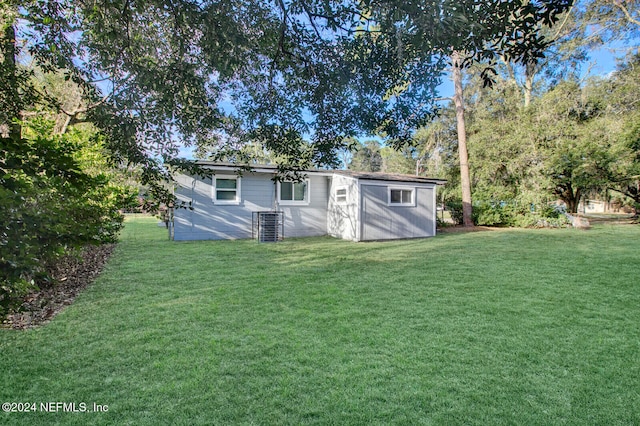 rear view of property featuring a lawn