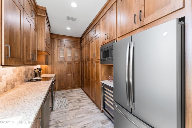 1869 S 2nd St, Jacksonville Beach, FL 32250 - kitchen with freestanding refrigerator, built in microwave, beverage cooler, backsplash, and recessed lighting