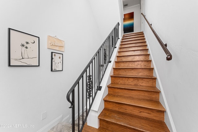 stairs featuring hardwood / wood-style floors