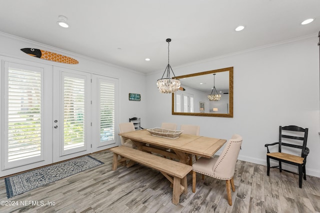 1869 S 2nd St, Jacksonville Beach, FL 32250 - dining room featuring light wood finished floors, a chandelier, french doors, crown molding, and baseboards