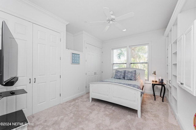 1869 S 2nd St, Jacksonville Beach, FL 32250 - bedroom with multiple closets, light colored carpet, crown molding, baseboards, and a ceiling fan