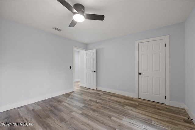 spare room featuring hardwood / wood-style flooring and ceiling fan