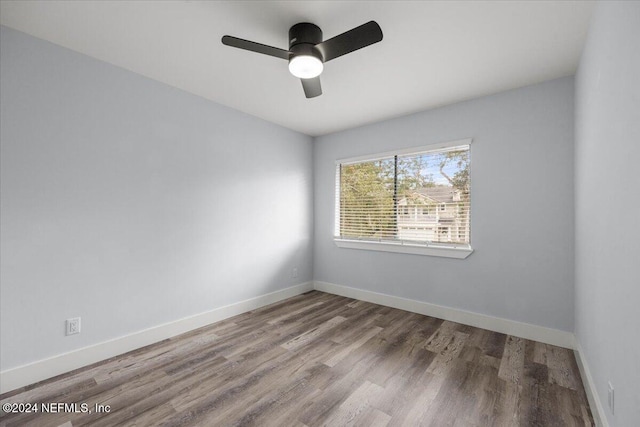 unfurnished room with hardwood / wood-style floors and ceiling fan