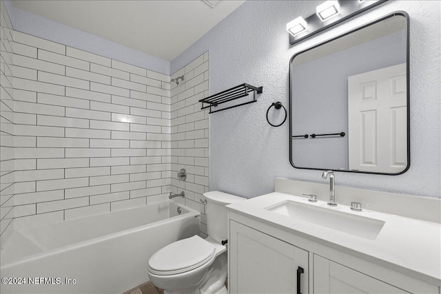 full bathroom with vanity, toilet, and tiled shower / bath combo