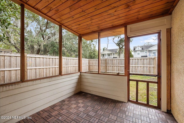 unfurnished sunroom with vaulted ceiling and wooden ceiling