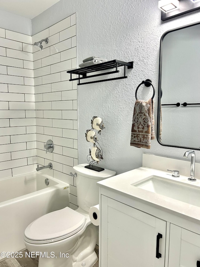 full bathroom with vanity, toilet, and tiled shower / bath combo