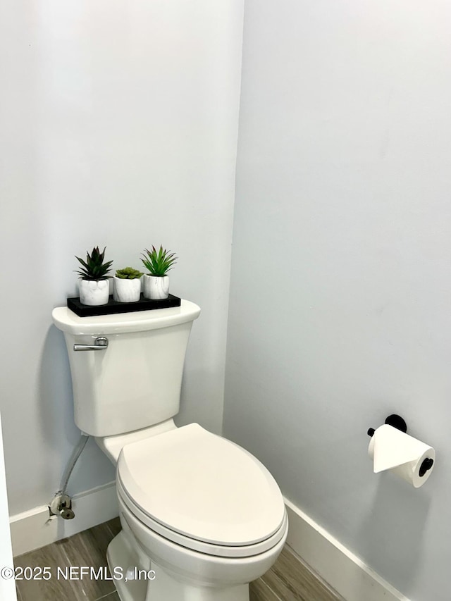 bathroom with wood-type flooring and toilet