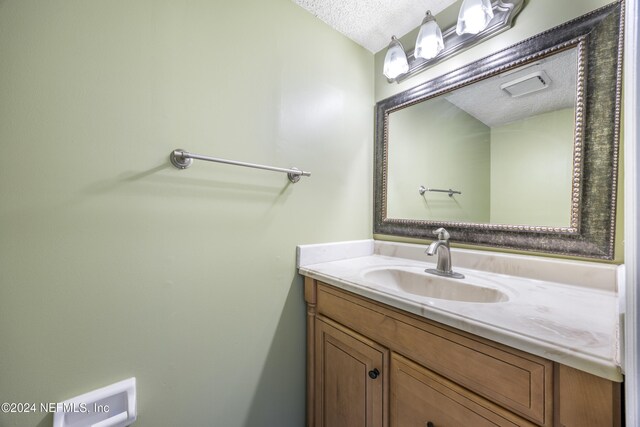 bathroom featuring vanity and a textured ceiling