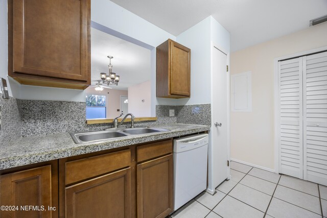 kitchen with dishwasher, decorative backsplash, sink, and a chandelier