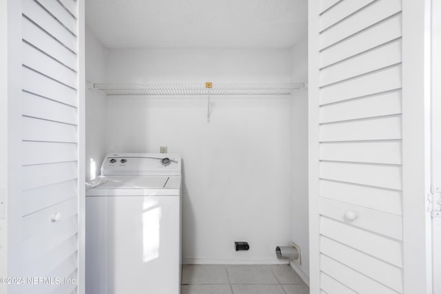 washroom with light tile patterned floors and washer / dryer