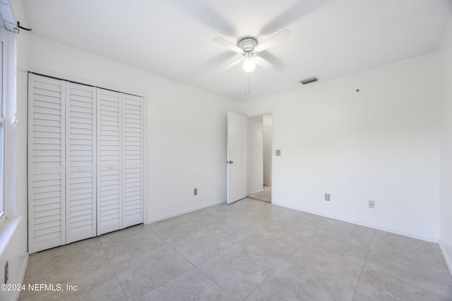 unfurnished bedroom featuring a closet and ceiling fan