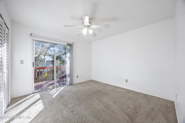 empty room with carpet floors and ceiling fan