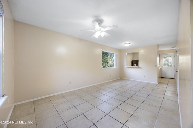 unfurnished room featuring ceiling fan and light tile patterned floors