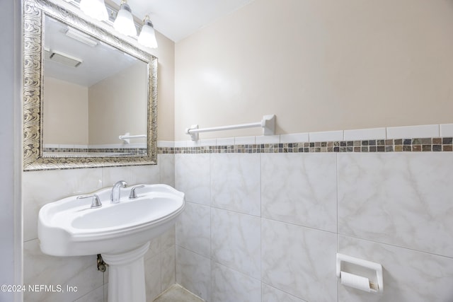 bathroom with tile walls