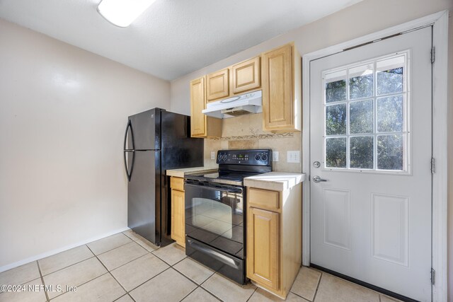 kitchen with black appliances, light brown cabinets, and light tile patterned flooring