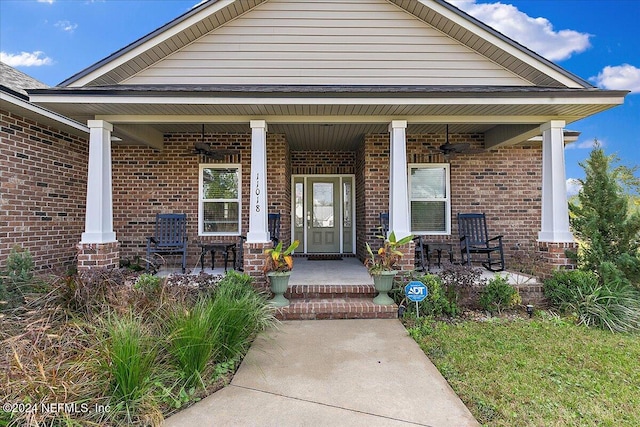 11018 Seneca Ln, Glen St Mary, FL 32040 - doorway to property with a porch, brick siding, and a ceiling fan