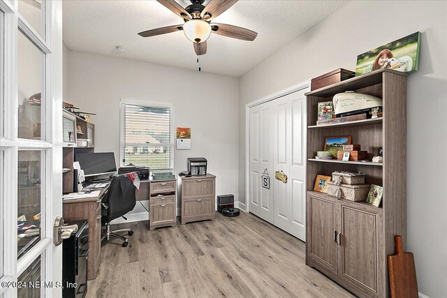 11018 Seneca Ln, Glen St Mary, FL 32040 - home office featuring light wood-style flooring, a ceiling fan, and a textured ceiling