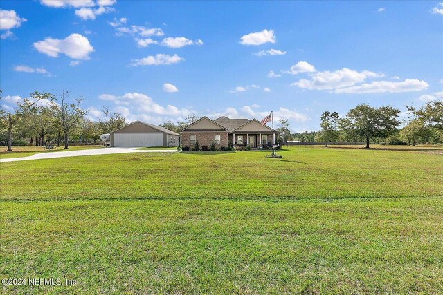 11018 Seneca Ln, Glen St Mary, FL 32040 - view of front facade featuring driveway, a front lawn, and a garage