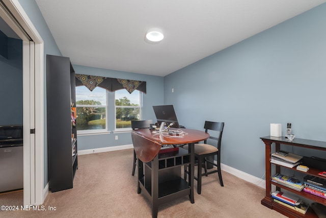 carpeted dining room with baseboards