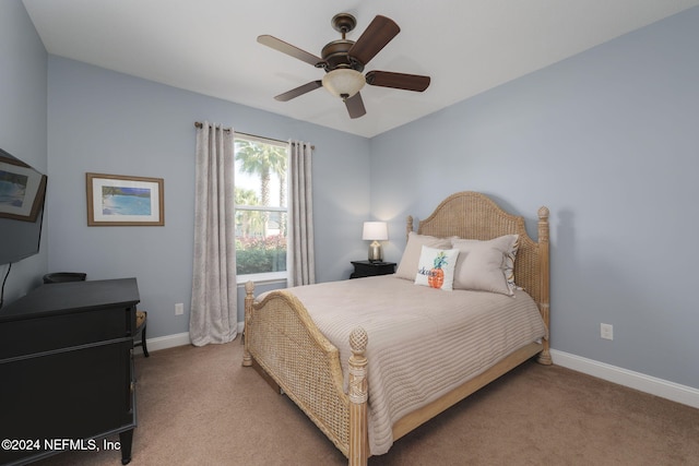 bedroom featuring light carpet, ceiling fan, and baseboards