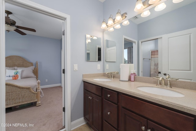 ensuite bathroom featuring ensuite bathroom, double vanity, a sink, and a ceiling fan