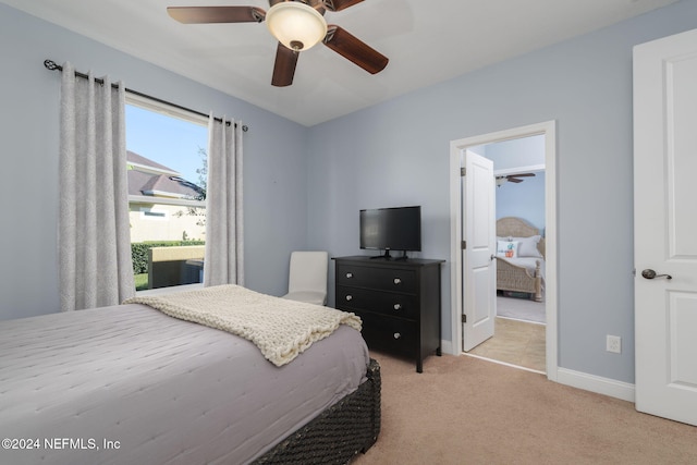 bedroom with baseboards, a ceiling fan, and light colored carpet