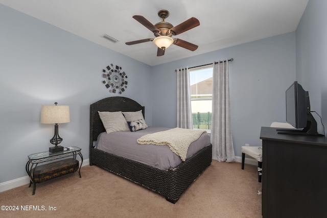 bedroom with baseboards, visible vents, and light colored carpet