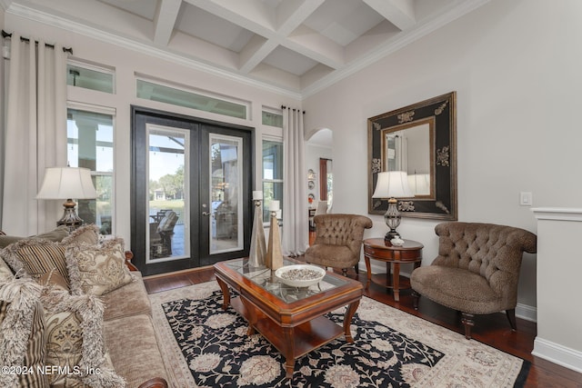 living room with baseboards, arched walkways, coffered ceiling, dark wood-type flooring, and beam ceiling