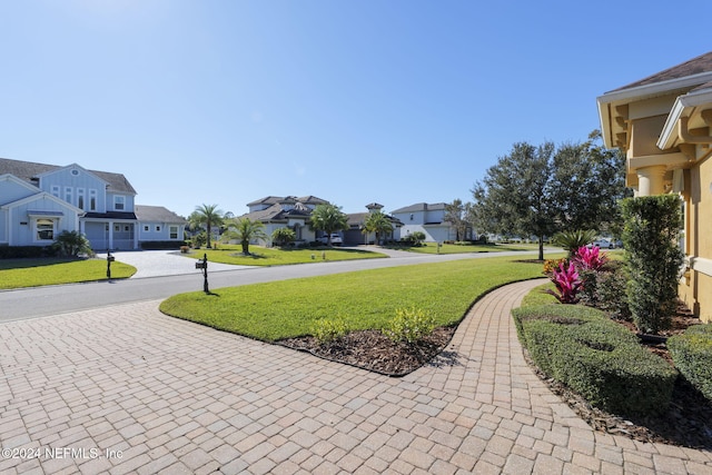 exterior space with decorative driveway and a residential view