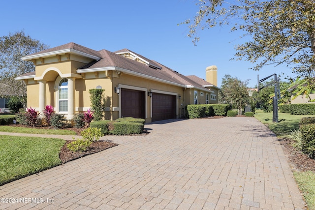 view of front facade with a front yard and a garage