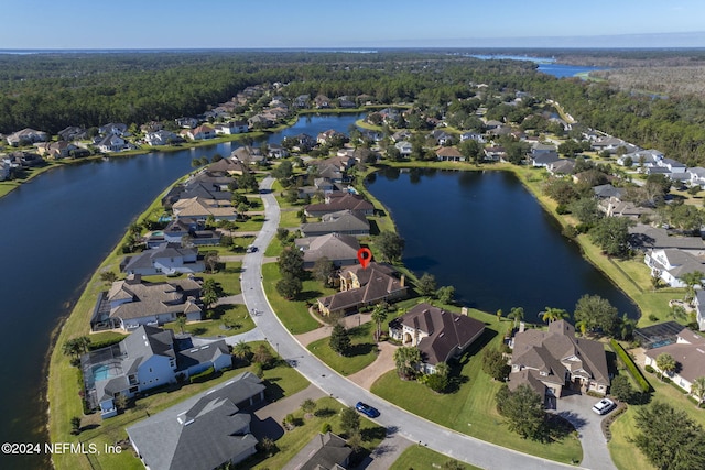 bird's eye view with a forest view, a water view, and a residential view