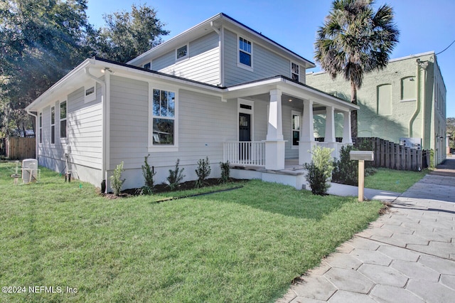 view of front facade featuring covered porch and a front lawn