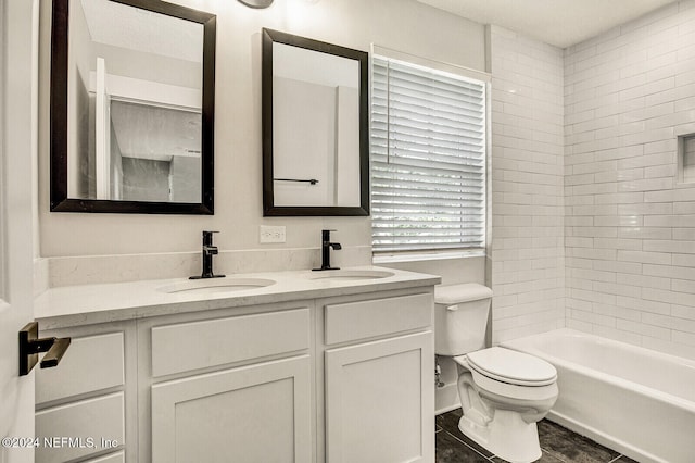 full bathroom featuring vanity, toilet, and tiled shower / bath combo