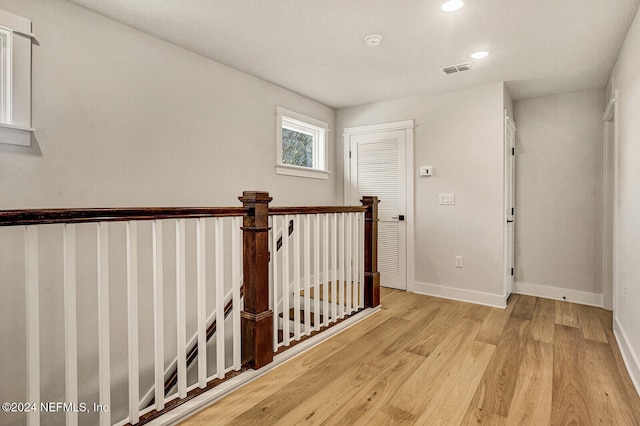 corridor with light hardwood / wood-style flooring